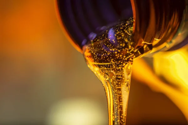 Golden Lubricant Pouring